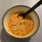 Fiery Chicken Ramen infused with a creamy garlic sauce